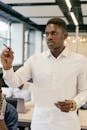 Young African American businessman presenting in a modern office setting.